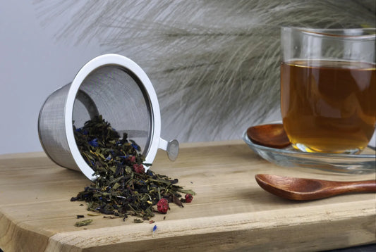 Grüner Tee Sencha Royal Star in Teetasse, bernsteinfarbener Aufguss, loser Tee im Sieb