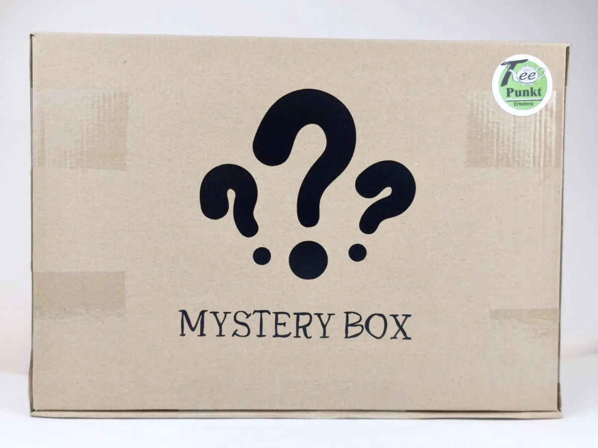 Geschlossener brauner Karton mit der Aufschrift "Mystery Box", Fragezeichen und TeePunkt-Erkelenz-Aufkleber