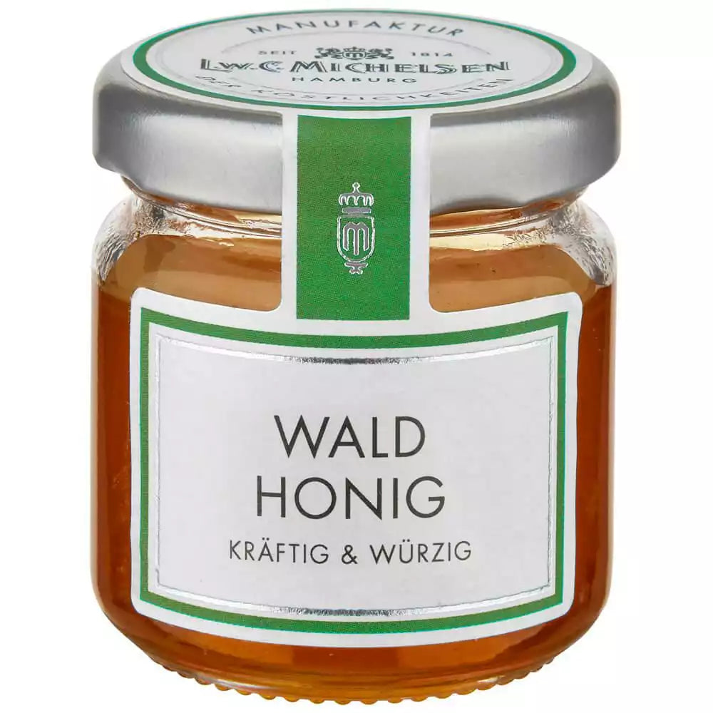 Waldhonig im kleinen Glas von L.W.C. Michelsen mit grünem Etikett kräftig und würzig auf weißem Hintergrund