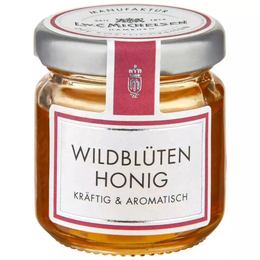 Wildblütenhonig im kleinen Glas von L.W.C. Michelsen mit rosa Etikett kräftig und aromatisch auf weißem Hintergrund